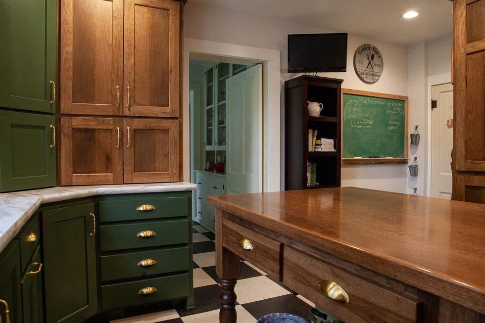 Custom kitchen cabinetry in stain and green paint