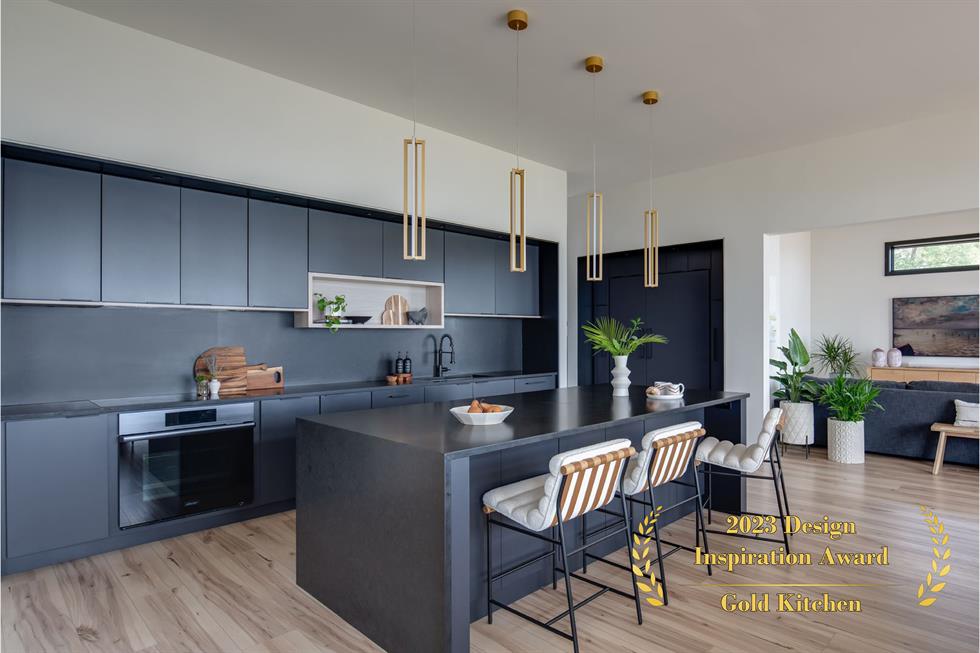 Black minimalist kitchen with light wood flooring