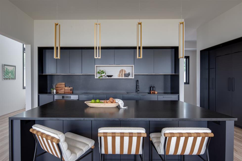 Black minimalist kitchen with light wood flooring